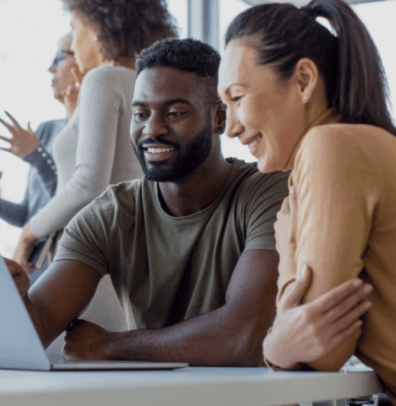 Two people using a laptop