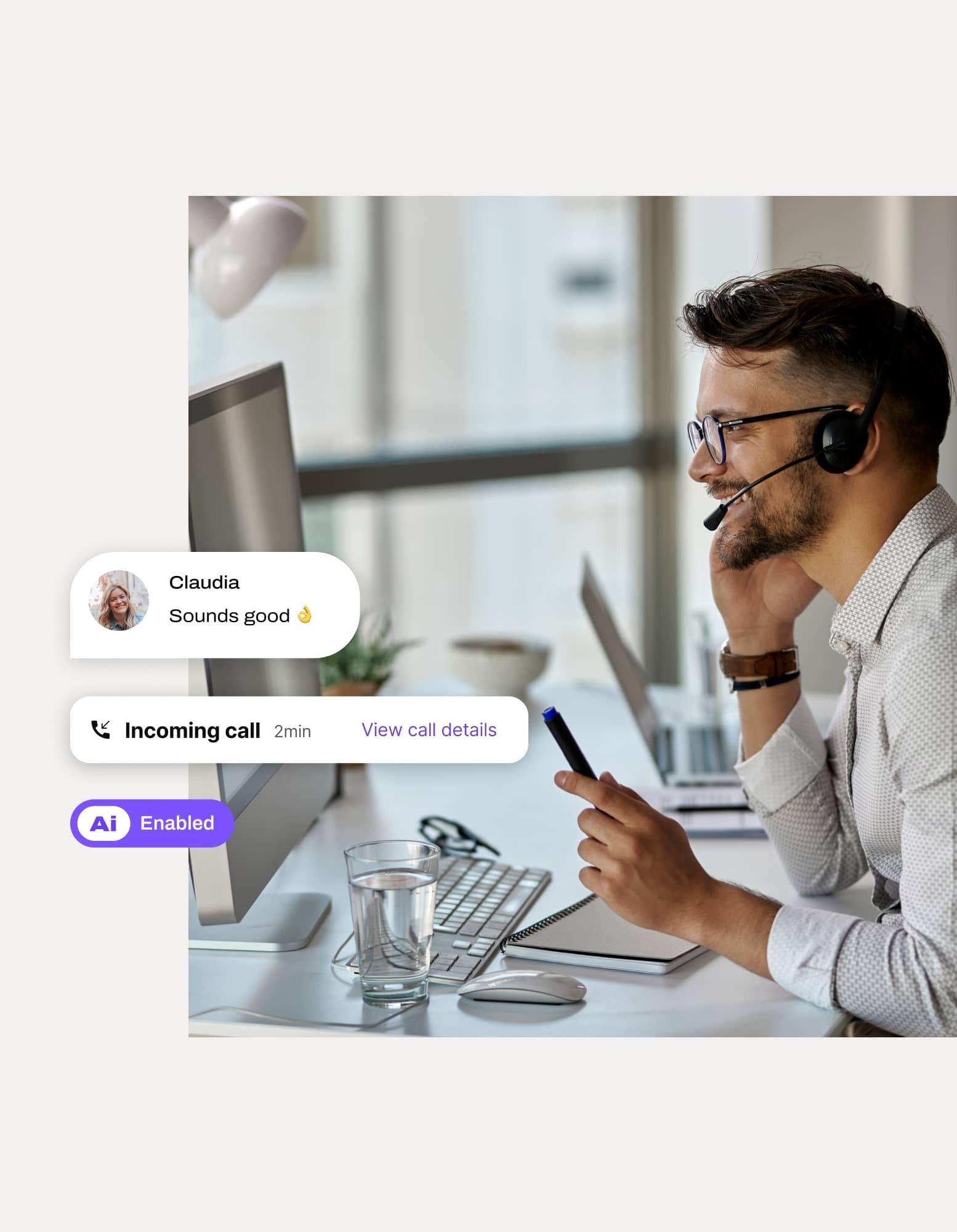 A man sitting at a desk on a phone call with Dialpad's Ai CSAT feature overlaid on top