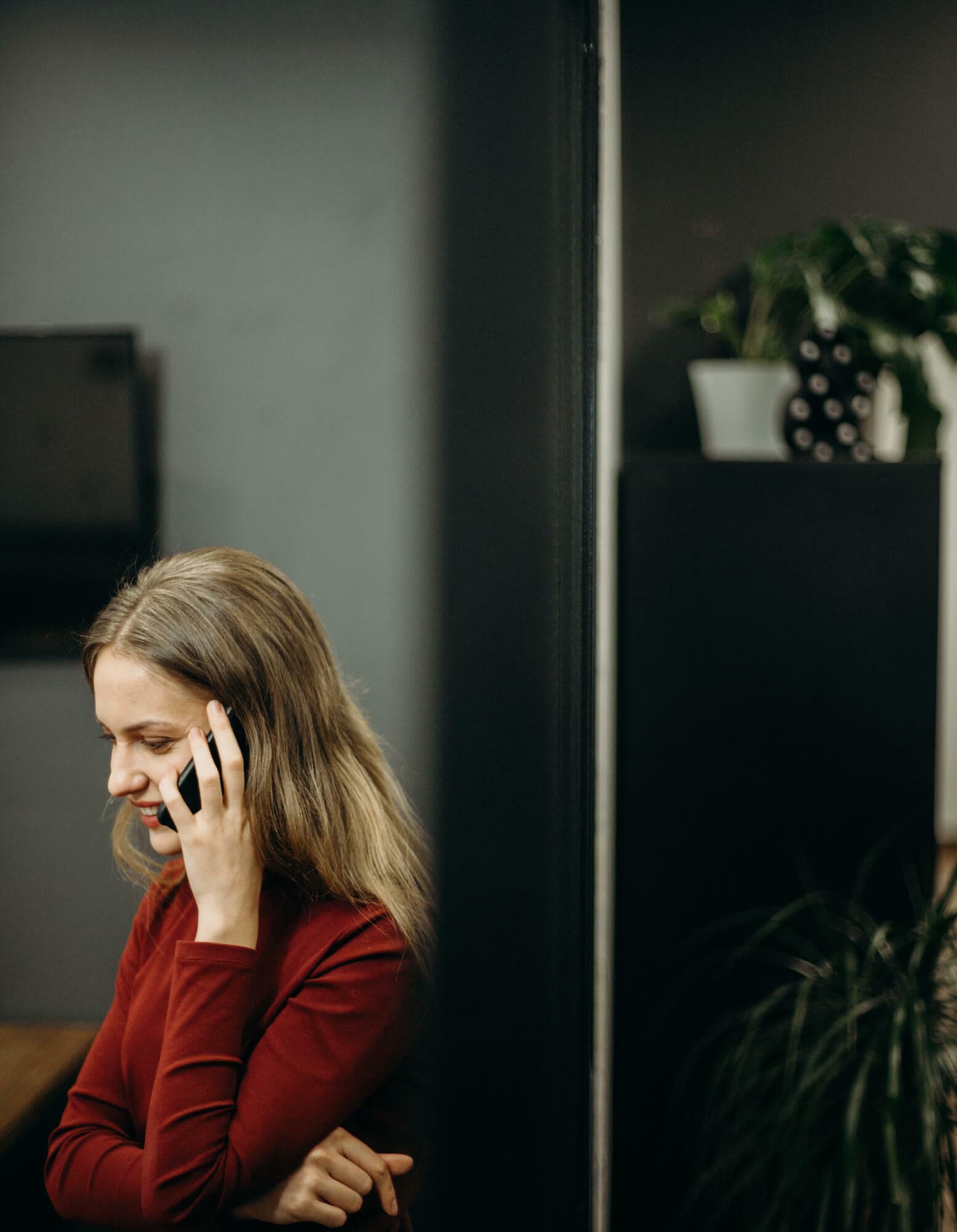 Work from home employee talking on her mobile device.