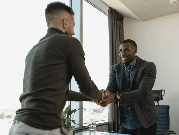 A recruiter shaking hands with a job applicant