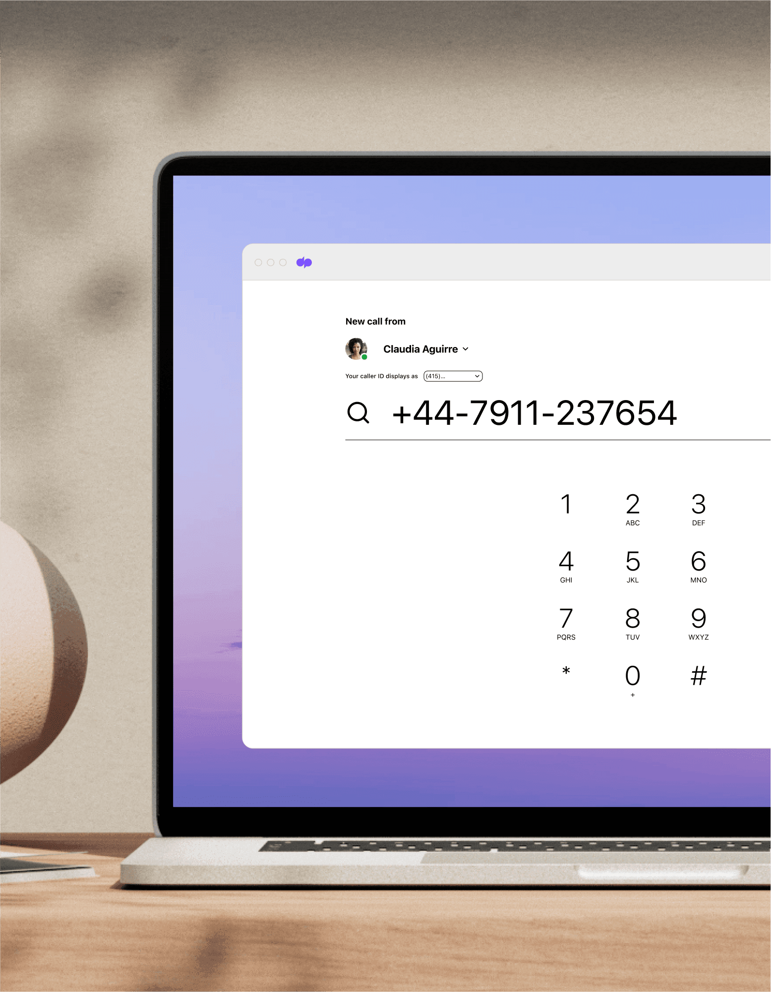 Computer monitor showing someone making a call from an international business number using Dialpad