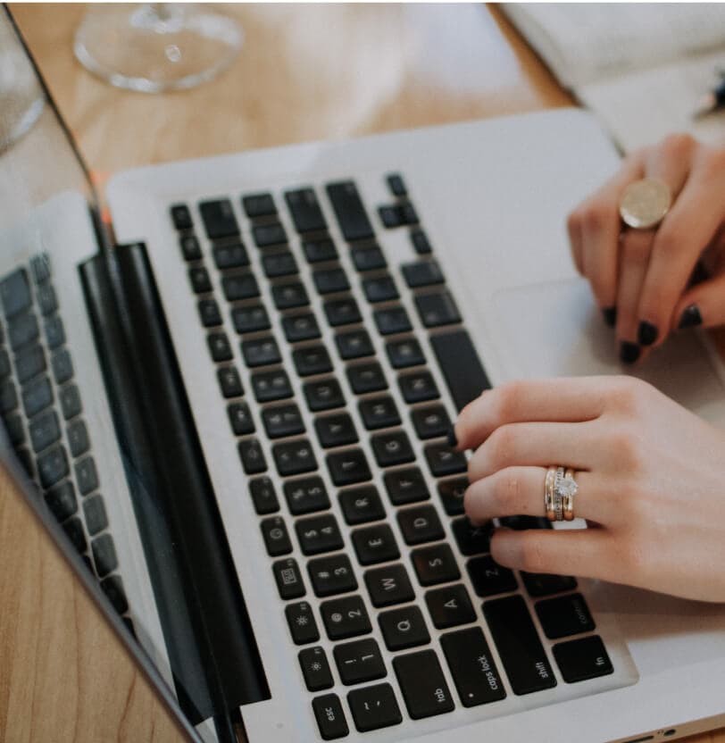 A hand typing on the keyboard