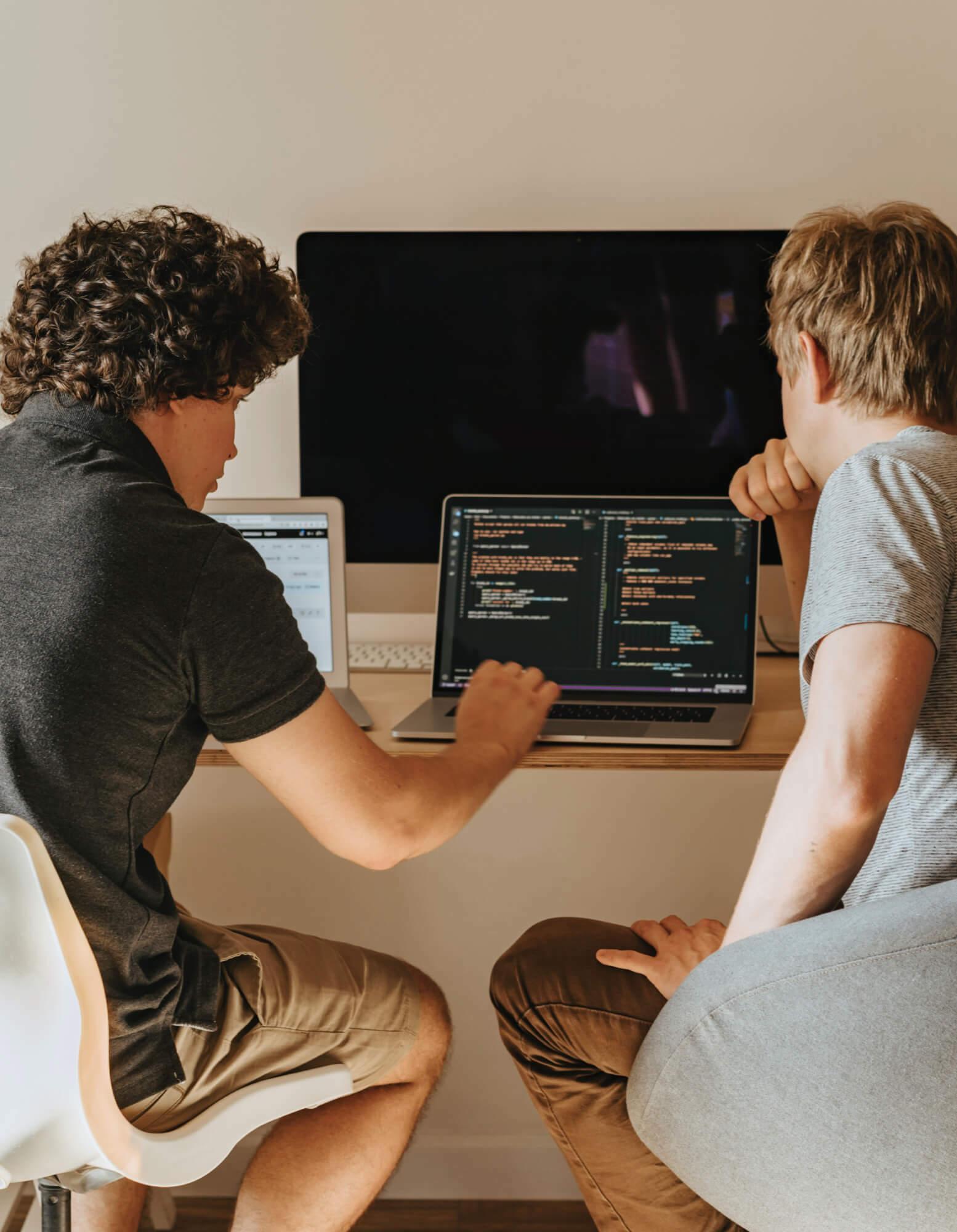 Two engineers working at a computer