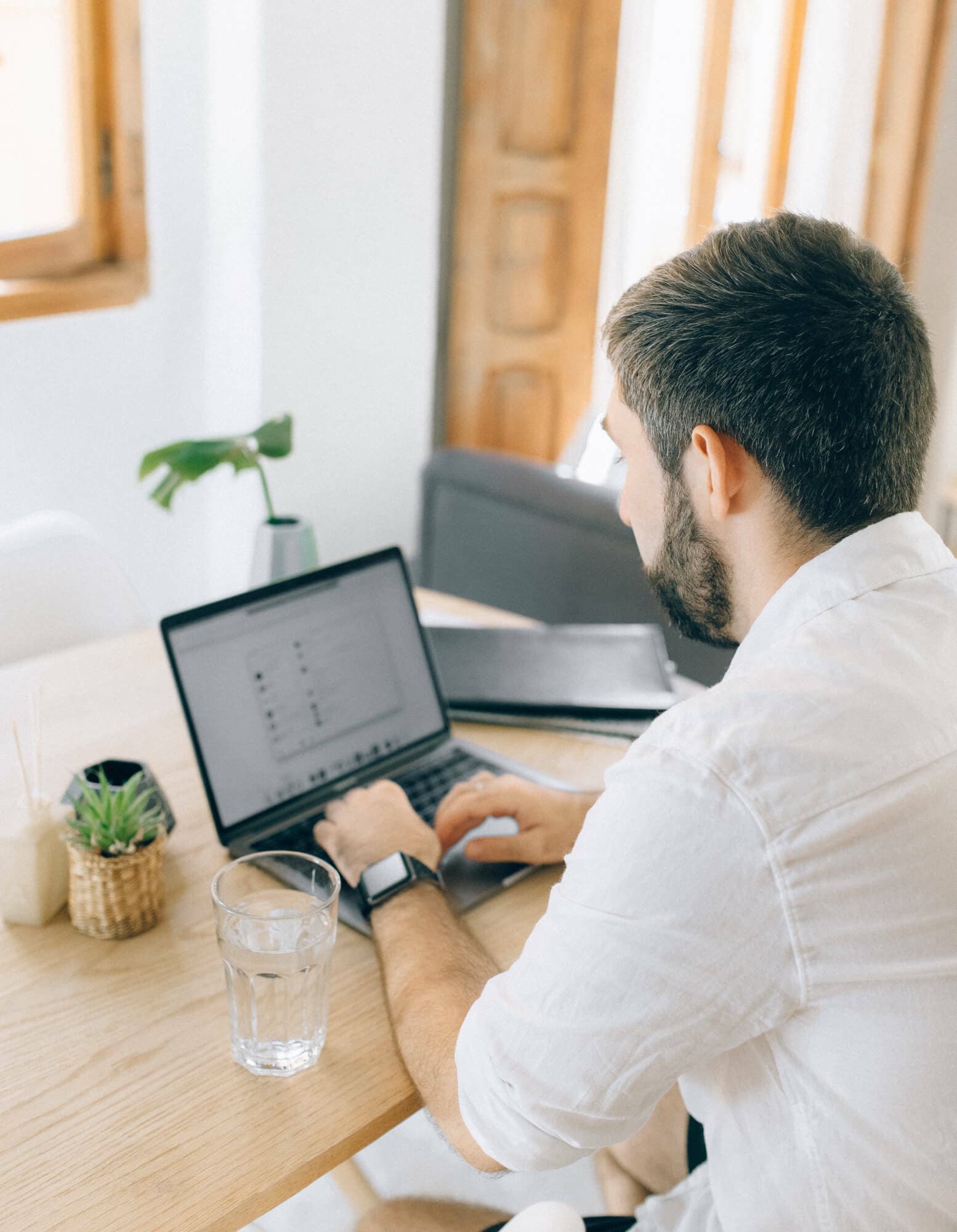 A man working at a laptop at home